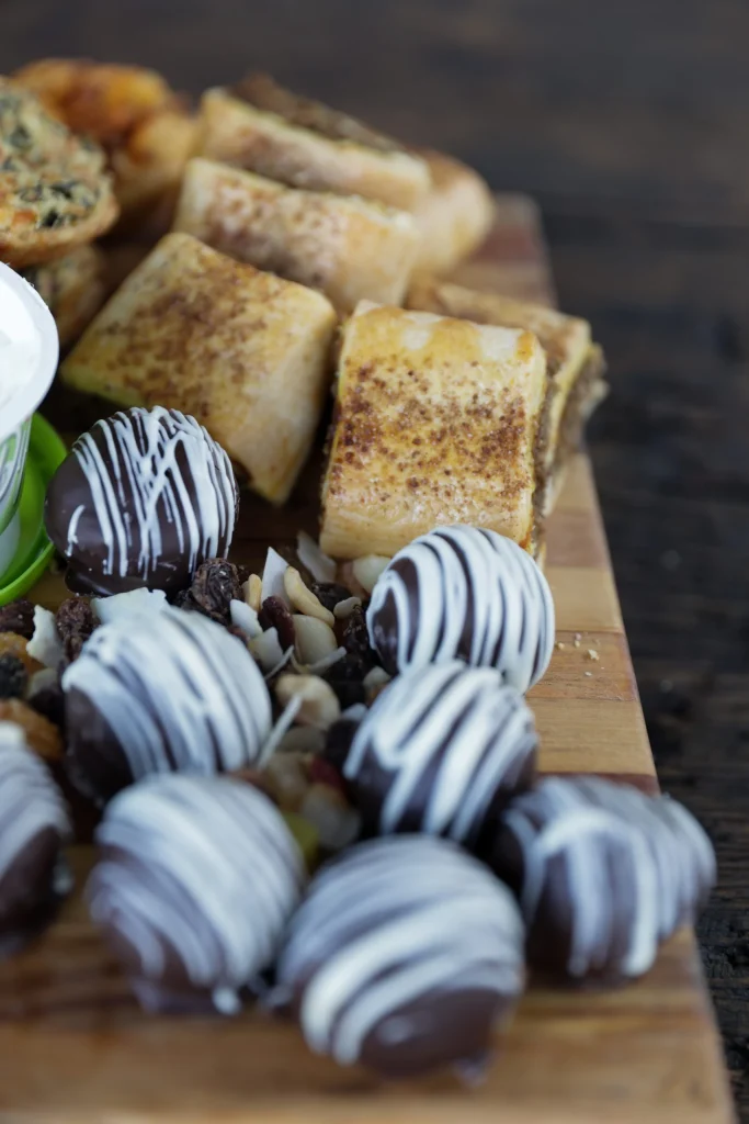 Luxury snack and drinks setup with chocolate-dipped strawberries and quiches at a Free State hunting lodge.