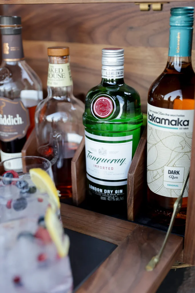 Premium gin and rum selection at a luxury Free State hunting lodge’s open-air bar setup.