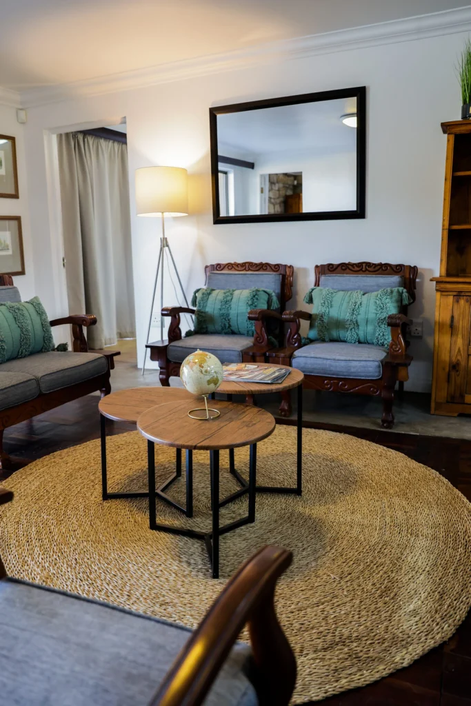 Warm and inviting dining room with wooden furniture and leather seating at a luxurious Free State hunting lodge.